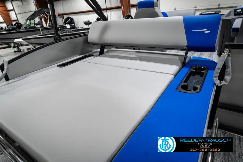 Slide: The Image of 2025 Bennington 20 SSB boat interior with gray and blue seating, showcased indoors. - 41