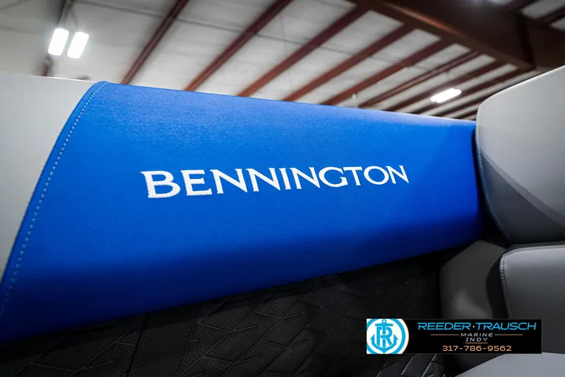 Slide: The Image of 2025 Bennington 20 SSB boat interior with blue upholstery and logo. - 43