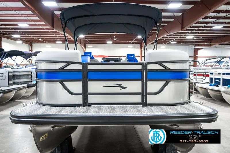 Slide: The Image of 2025 Bennington 20 SSB pontoon boat in showroom, featuring sleek design and blue accents. - 5