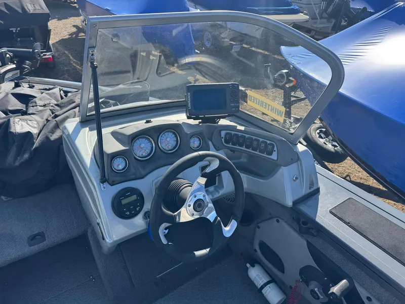 Slide: The Image of 2017 Tracker Targa V-18 Combo boat dashboard with steering wheel and gauges. - 10