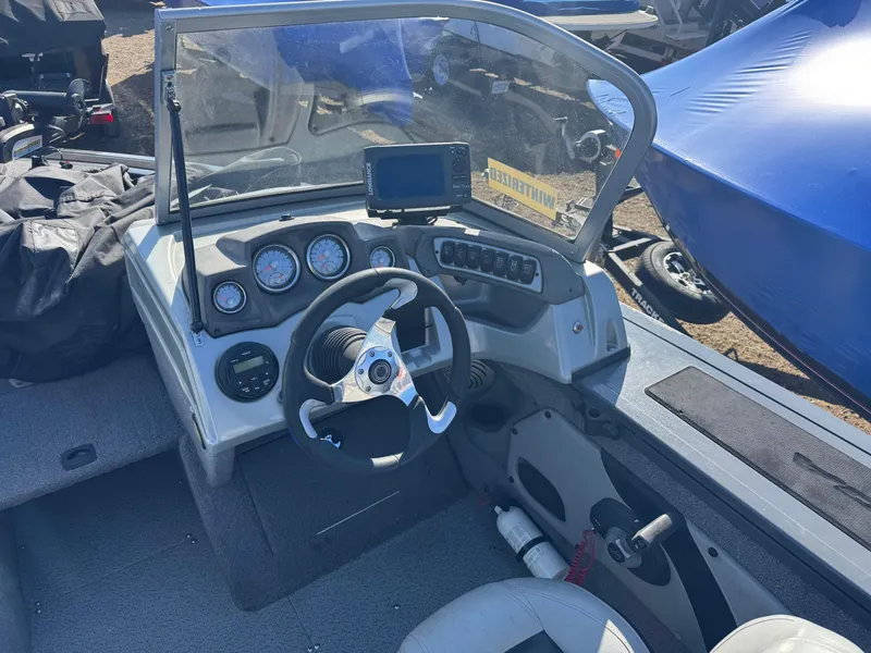 Slide: The Image of 2017 Tracker Targa V-18 Combo boat dashboard with steering wheel and gauges. - 11