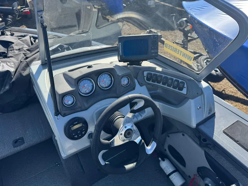 Slide: The Image of 2017 Tracker Targa V-18 Combo boat dashboard with steering wheel and gauges. - 13