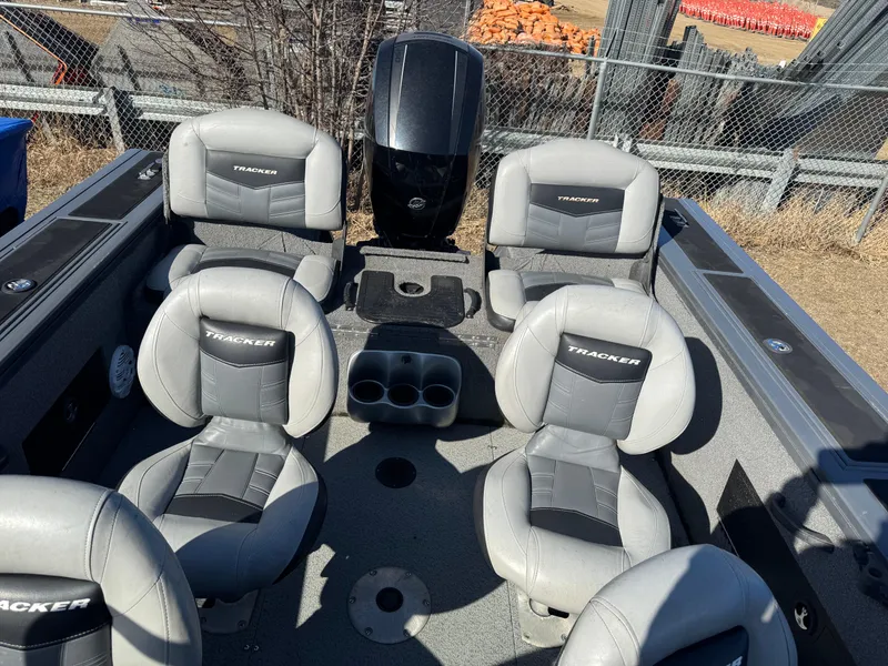 Slide: The Image of 2017 Tracker Targa V-18 Combo boat interior with four seats and cup holders. - 14