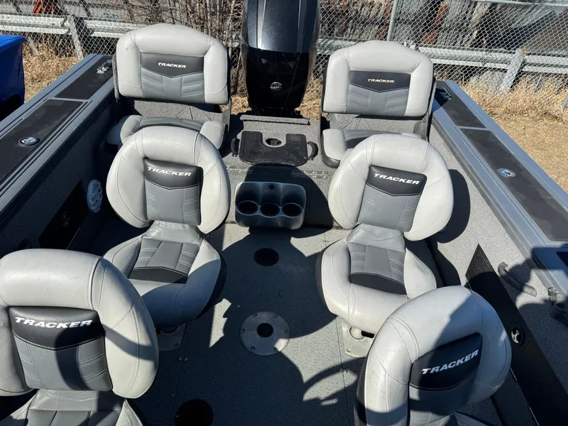 Slide: The Image of 2017 Tracker Targa V-18 Combo boat interior with gray seating and cup holders. - 16