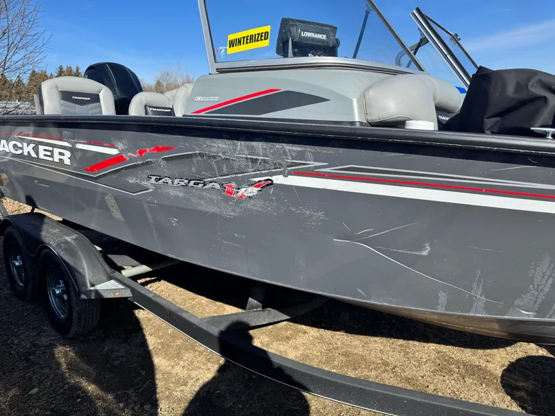Slide: The Image of 2017 Tracker Targa V-18 Combo boat on trailer, showing exterior scratches. - 3