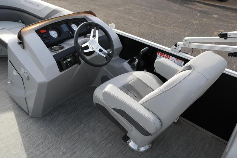 Slide: The Image of 2021 Bennington SX 20 Quad Bench boat interior with steering wheel and captain's chair. - 11