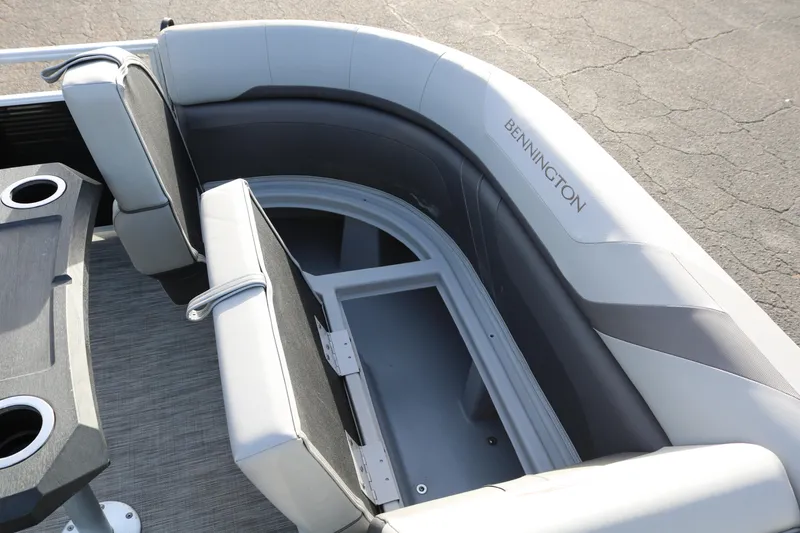 Slide: The Image of 2021 Bennington SX 20 Quad Bench interior with storage compartment and cup holders. - 15
