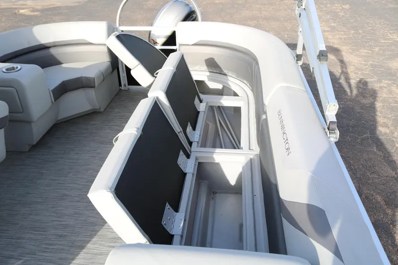 Slide: The Image of 2021 Bennington SX 20 Quad Bench pontoon boat with open storage compartments. - 18