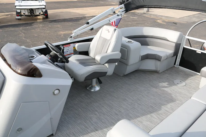 Slide: The Image of 2021 Bennington SX 20 Quad Bench boat interior with gray seating and steering console. - 9