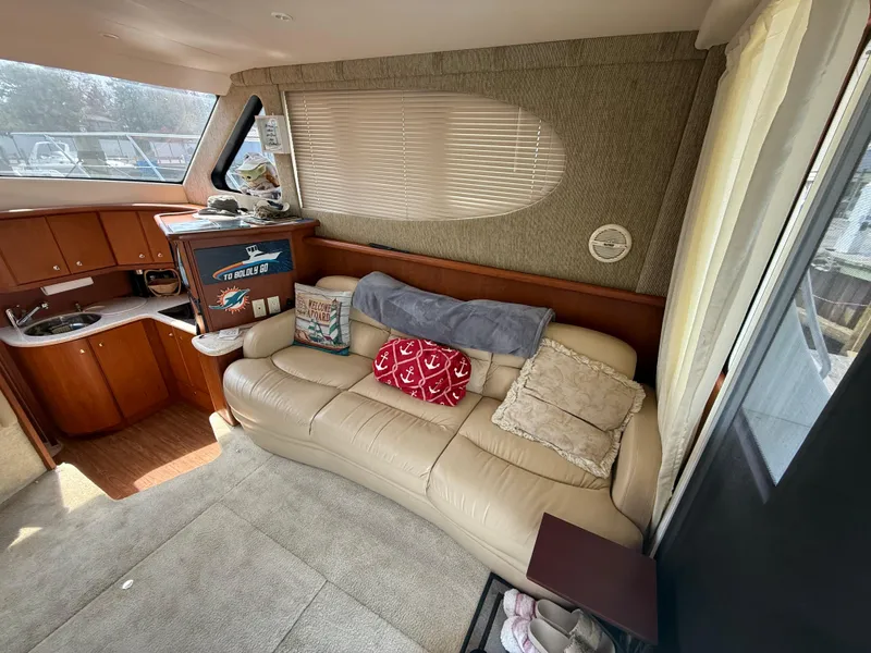 Slide: The Image of Interior of 2004 Silverton 34 Convertible yacht with beige leather sofa and kitchenette. - 11