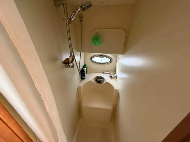 Slide: The Image of 2004 Silverton 34 Convertible boat shower with porthole and showerhead. - 18