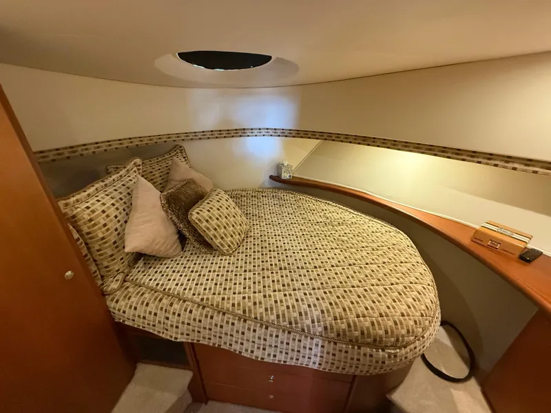 Slide: The Image of 2004 Silverton 34 Convertible yacht cabin with cozy bed and decorative pillows. - 19