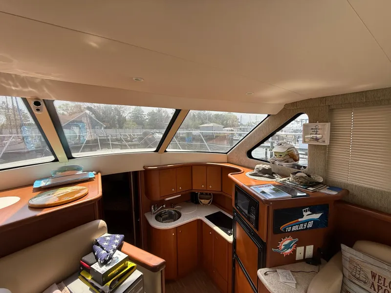 Slide: The Image of Interior of 2004 Silverton 34 Convertible yacht with kitchen and seating area. - 20
