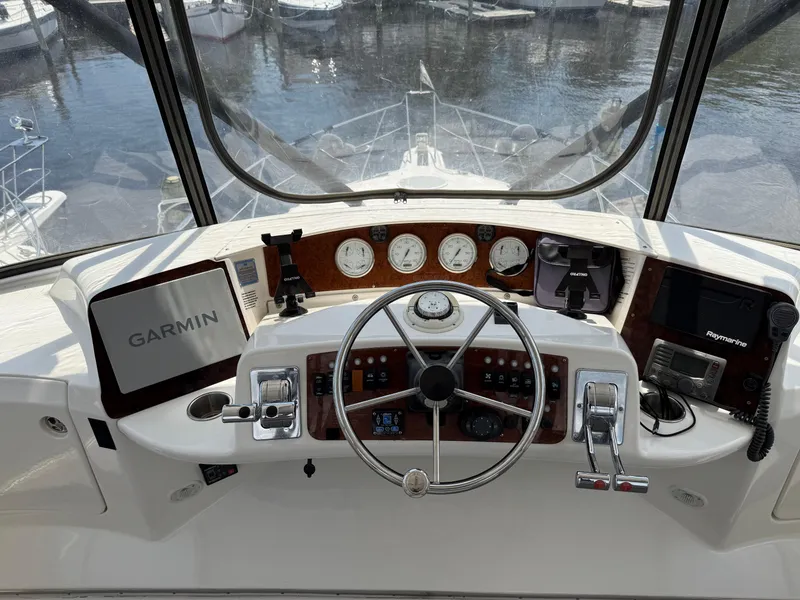 Slide: The Image of 2004 Silverton 34 Convertible boat helm with Garmin navigation and control instruments. - 6