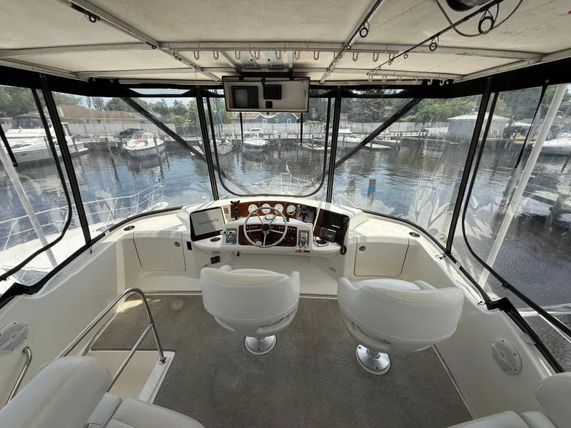 Slide: The Image of Interior view of 2004 Silverton 34 Convertible yacht cockpit with dual seats and navigation equipment. - 7