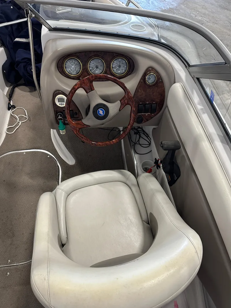 Slide: The Image of 2003 Four Winns 180 Horizon boat cockpit with steering wheel and gauges. - 10