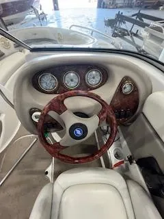 Slide: The Image of 2003 Four Winns 180 Horizon boat dashboard with wood-accented steering wheel and gauges. - 11