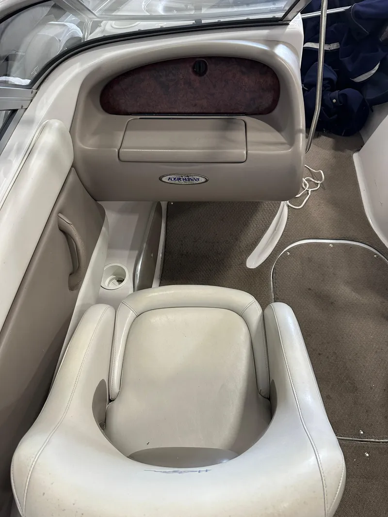 Slide: The Image of 2003 Four Winns 180 Horizon boat interior with beige seating and dashboard. - 12