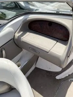 Slide: The Image of 2003 Four Winns 180 Horizon boat interior with beige seating and dashboard. - 13
