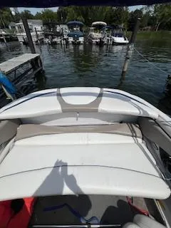 Slide: The Image of 2003 Four Winns 180 Horizon boat docked at a marina with surrounding watercraft. - 14