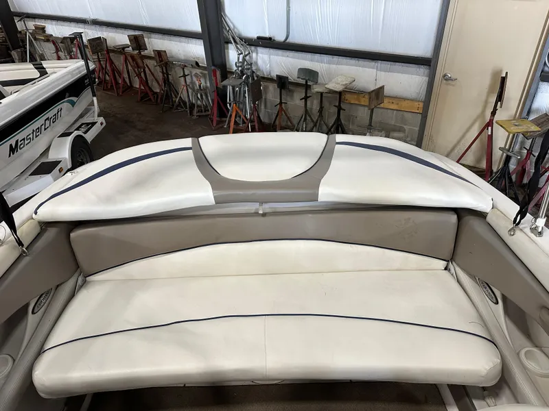 Slide: The Image of 2003 Four Winns 180 Horizon boat interior with white seating in a storage facility. - 15
