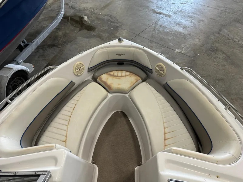 Slide: The Image of 2003 Four Winns 180 Horizon boat interior with white seating and visible wear. - 16