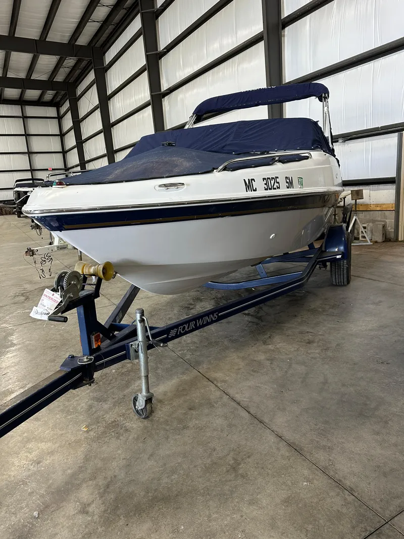 Slide: The Image of 2003 Four Winns 180 Horizon boat on trailer in indoor storage facility. - 3