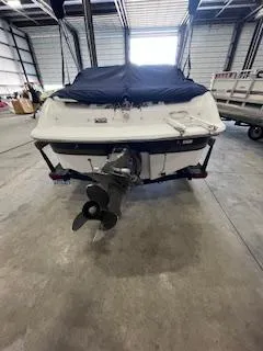 Slide: The Image of 2003 Four Winns 180 Horizon boat in storage, rear view with covered top. - 6