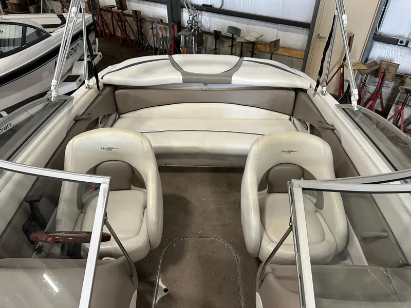 Slide: The Image of 2003 Four Winns 180 Horizon boat interior with white seating and steering wheel. - 8
