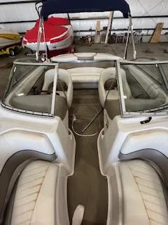 Slide: The Image of 2003 Four Winns 180 Horizon boat interior with seating and steering wheel in storage. - 9
