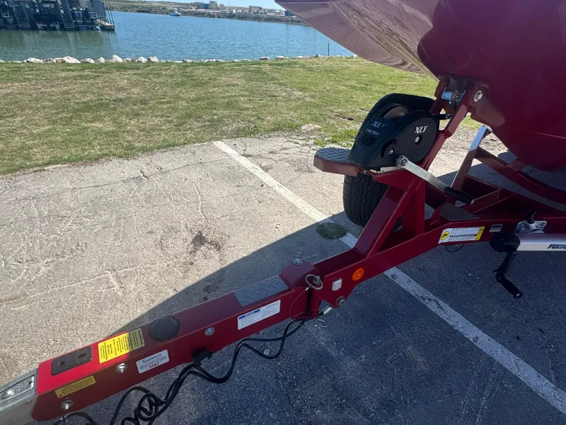 Slide: The Image of Trailer hitch of a 2019 MasterCraft X46 boat near a waterfront. - 10