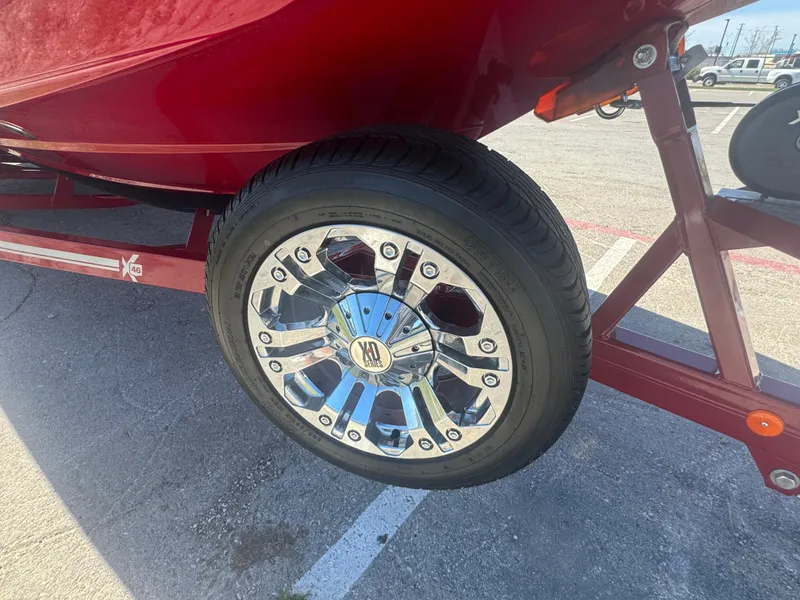 Slide: The Image of 2019 MasterCraft X46 boat trailer with shiny chrome wheel in parking lot. - 11