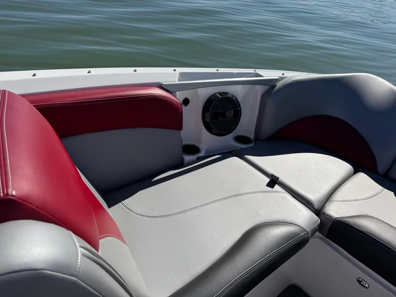 Slide: The Image of 2019 MasterCraft X46 boat interior with red and gray seating, on calm water. - 13