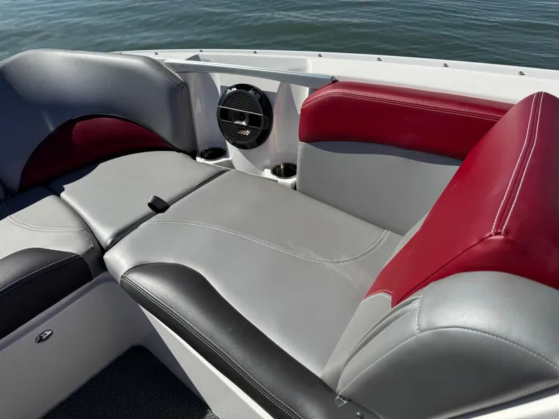 Slide: The Image of 2019 MasterCraft X46 boat interior with gray and red seating, cup holders, and speaker. - 14