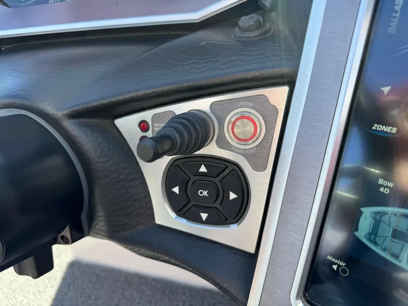 Slide: The Image of Control panel of a 2019 MasterCraft X46 boat with joystick and display screen. - 21