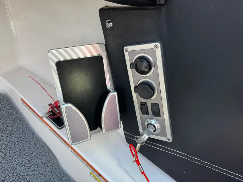 Slide: The Image of Control panel and holder on a 2019 MasterCraft X46 boat. - 22