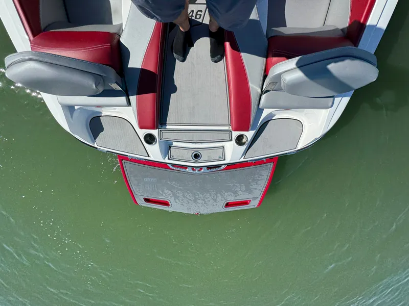 Slide: The Image of 2019 MasterCraft X46 boat with red and gray seating, viewed from above on water. - 29