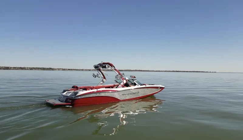 Slide: The Image of 2019 MasterCraft X46 boat on calm water under clear blue sky. - 3