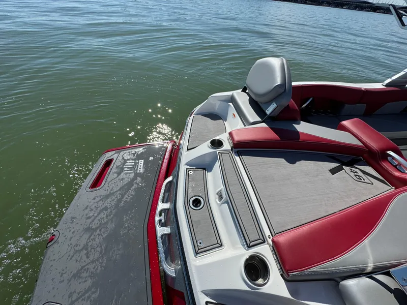 Slide: The Image of 2019 MasterCraft X46 boat with red and gray seating on calm water. - 30