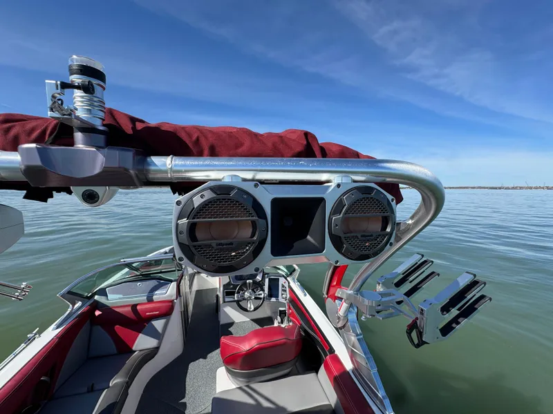 Slide: The Image of 2019 MasterCraft X46 boat with speakers and wakeboard racks on a sunny day. - 34