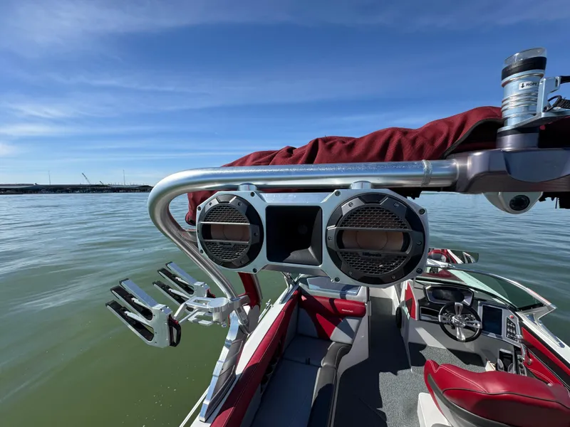 Slide: The Image of 2019 MasterCraft X46 boat with speakers and wakeboard racks on a sunny day. - 35