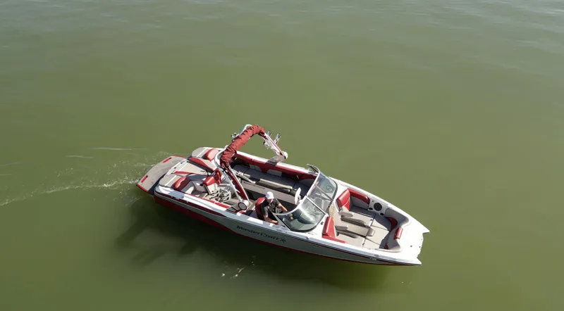 Slide: The Image of 2019 MasterCraft X46 boat on calm green water, aerial view. - 4