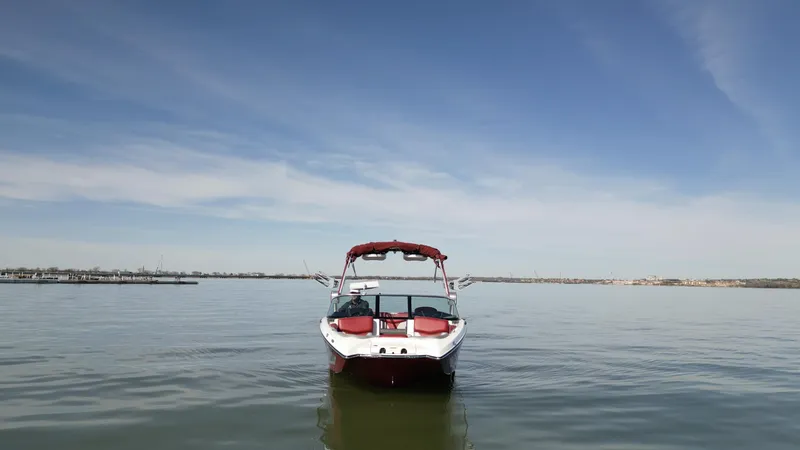 Slide: The Image of 2019 MasterCraft X46 boat on calm water under clear blue sky. - 42