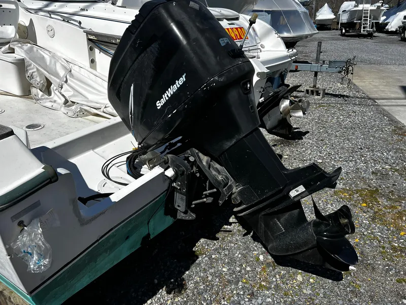 Slide: The Image of 1979 Aquasport 22-2 boat with a Saltwater outboard motor in a marina. - 4