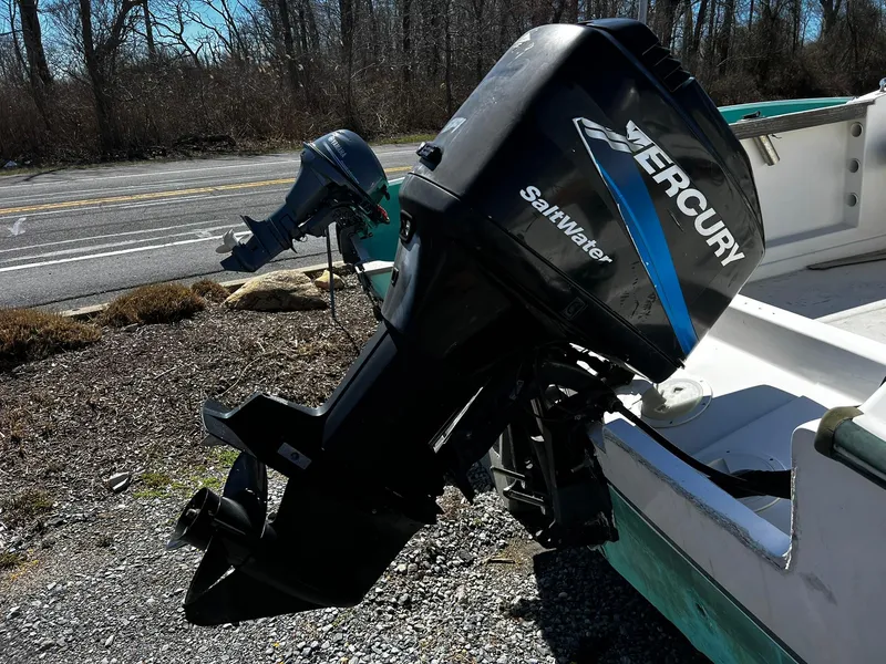 Slide: The Image of 1979 Aquasport 22-2 boat with Mercury Saltwater outboard motor, parked outdoors. - 5