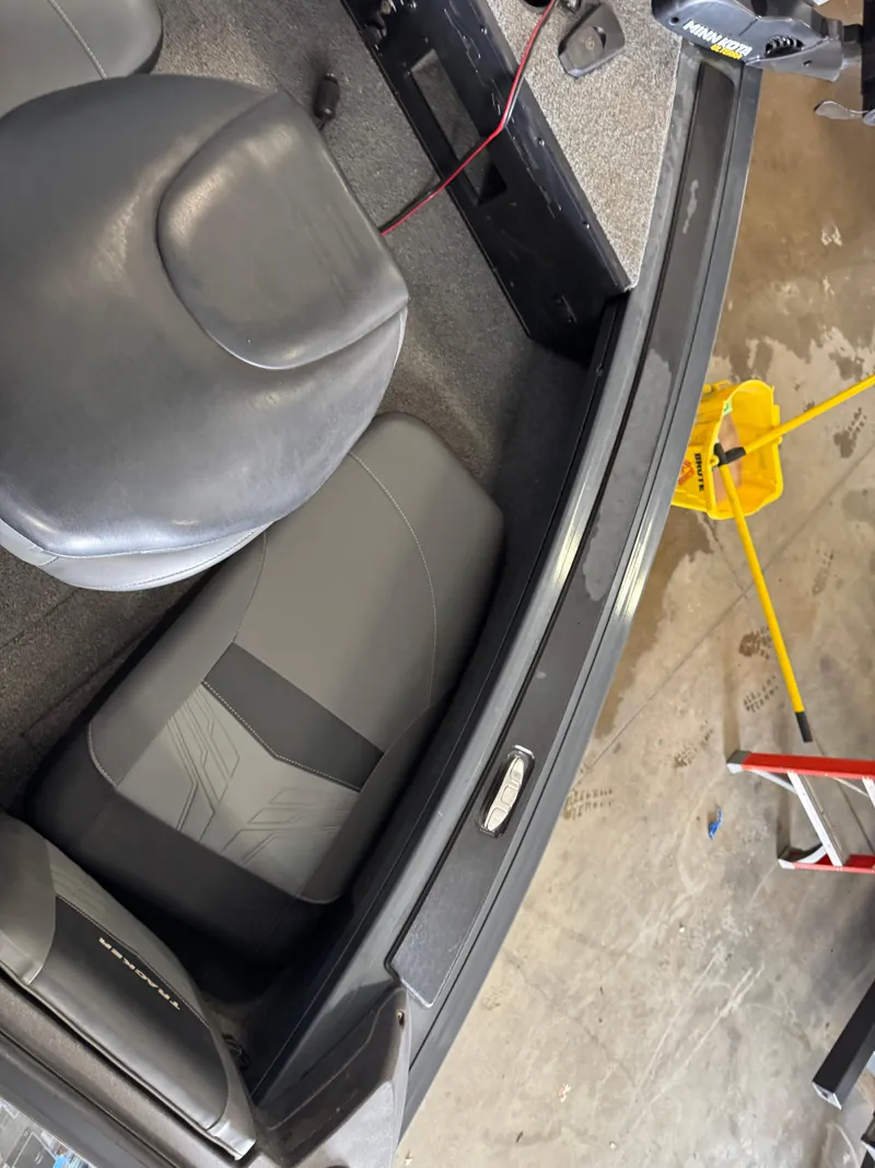 Slide: The Image of 2022 Tracker Targa V-18 Combo boat interior with gray seating and equipment. - 12