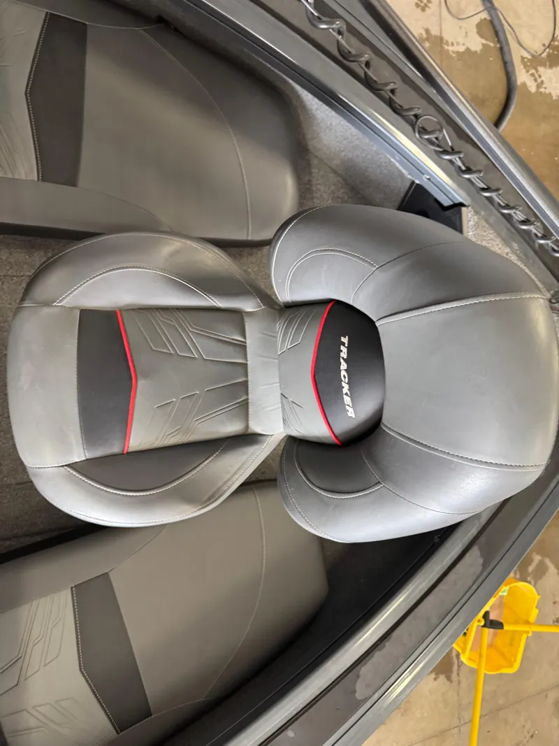 Slide: The Image of 2022 Tracker Targa V-18 Combo boat seat with gray and red design. - 13