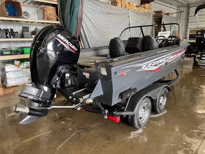 Slide: The Image of 2022 Tracker Targa V-18 Combo boat with Mercury engine in a garage setting. - 3