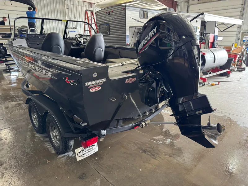 Slide: The Image of 2022 Tracker Targa V-18 Combo boat with Mercury outboard motor in a garage setting. - 4