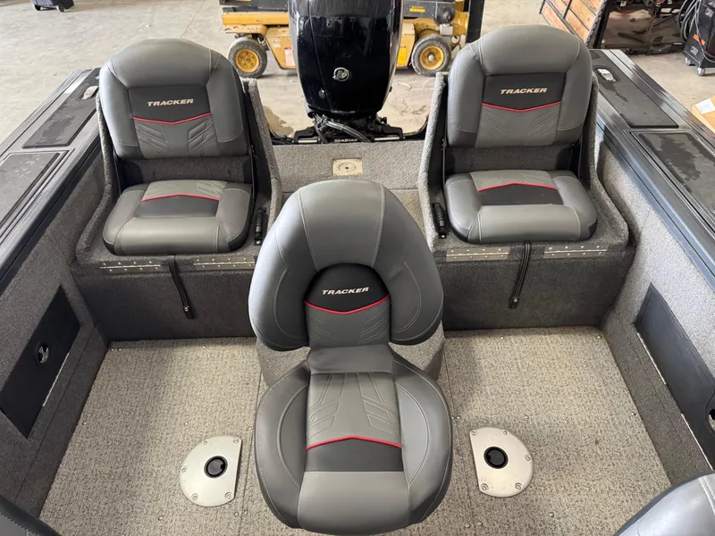 Slide: The Image of 2022 Tracker Targa V-18 Combo boat interior with three gray seats. - 6